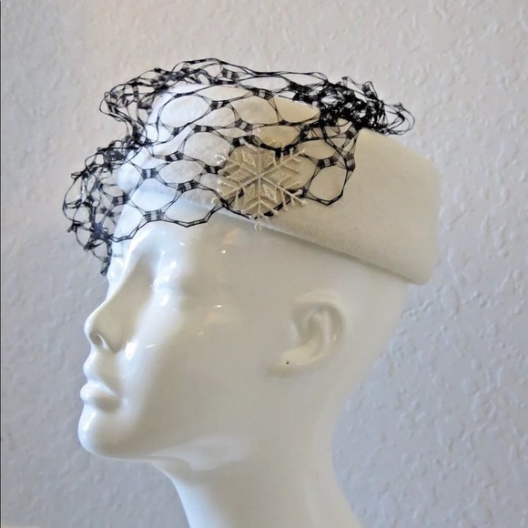 White hairpiece hat with black snowflake veil